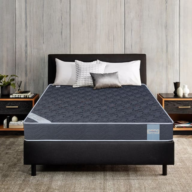 Coir Bond Mattress high-density coir mattress premium comfort mattress on a bed frame with pillows in a bedroom setting.