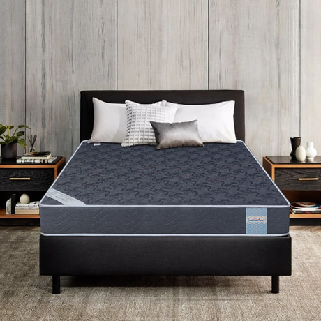 Coir Bond Mattress high-density coir mattress premium comfort mattress on a bed frame with pillows in a bedroom setting.