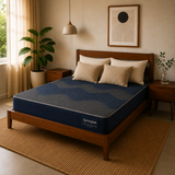 A Dual Comfort Reversible Mattress on a wooden bed frame in a styled bedroom setting with beige walls, a hanging lamp, a potted plant, and a woven rug.