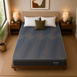 A Springtek Euro Top Hybrid Latex Pocket Spring Mattress on a wooden bed frame in a styled bedroom setting, featuring a blue and gray wavy patterned mattress, white pillows, and bedside lamps.