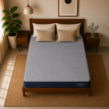 A bed with a light blue patterned Springtek Ortho Pocket Memory Foam Spring Mattress and matching pillows in a styled bedroom setting with wooden furniture, plants, and warm neutral decor.