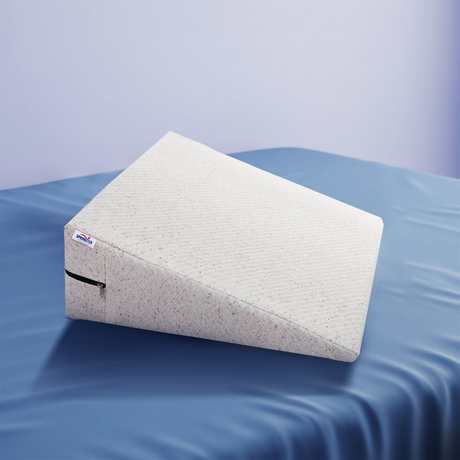 Wedge-shaped Springtek Wedge Pillow angled view supportive foam wedge on a blue water-like background